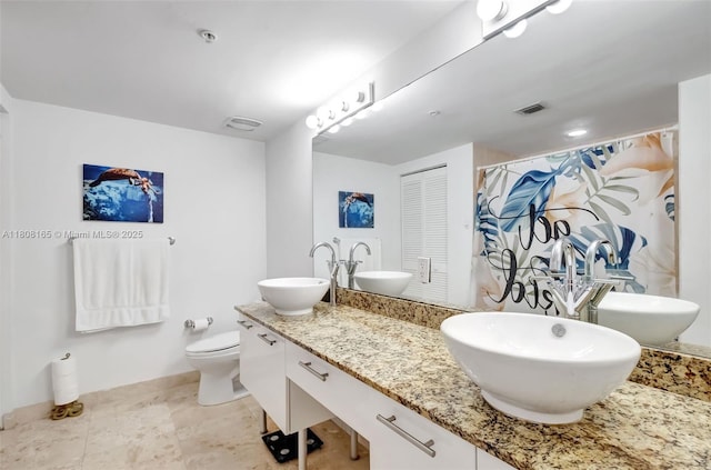 41 SE 5th St Unit 1012, Miami, FL 33131 - full bathroom featuring double vanity, toilet, and a shower with shower curtain