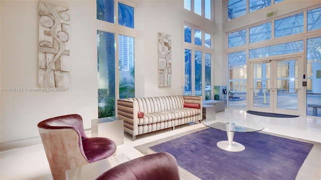 41 SE 5th St Unit 1012, Miami, FL 33131 - living area featuring french doors, plenty of natural light, and a towering ceiling