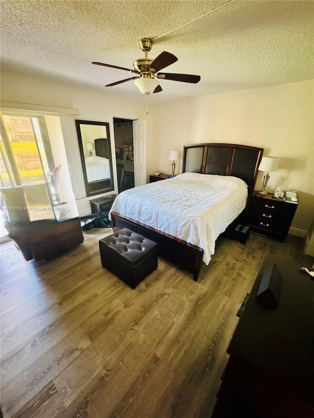 14360 Strathmore Ln Unit 102, Delray Beach, FL 33446 - bedroom with a textured ceiling, wood finished floors, a ceiling fan, and access to outside