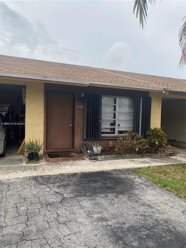 450 NW 46th St Unit 450, Deerfield Beach, FL 33064 - doorway to property featuring a shingled roof