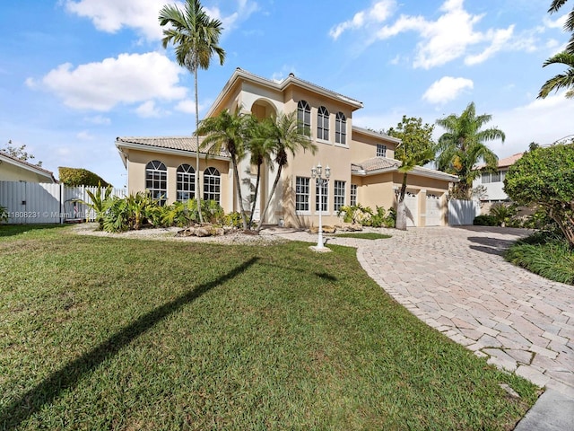 11230 SW 156th Ave, Miami, FL 33196 - mediterranean / spanish-style house with an attached garage, decorative driveway, stucco siding, and a gate