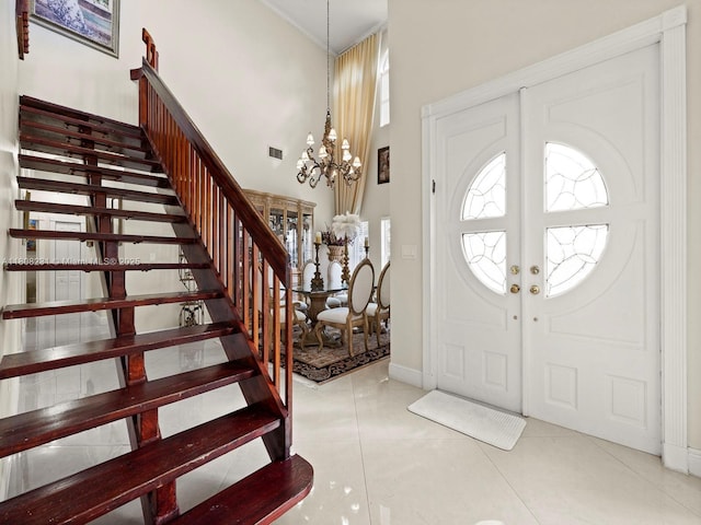 11230 SW 156th Ave, Miami, FL 33196 - tiled entrance foyer with stairs, a chandelier, baseboards, a high ceiling, and healthy amount of natural light