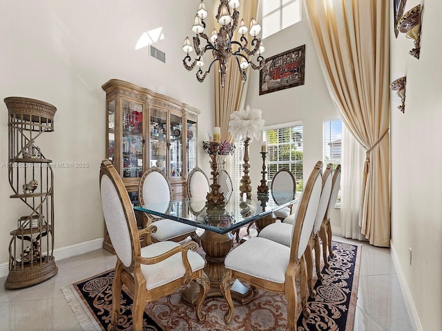 11230 SW 156th Ave, Miami, FL 33196 - dining room featuring a towering ceiling, a chandelier, light tile patterned floors, and baseboards