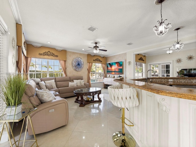 11230 SW 156th Ave, Miami, FL 33196 - living room featuring light tile patterned floors, crown molding, ceiling fan, a chandelier, and a textured ceiling