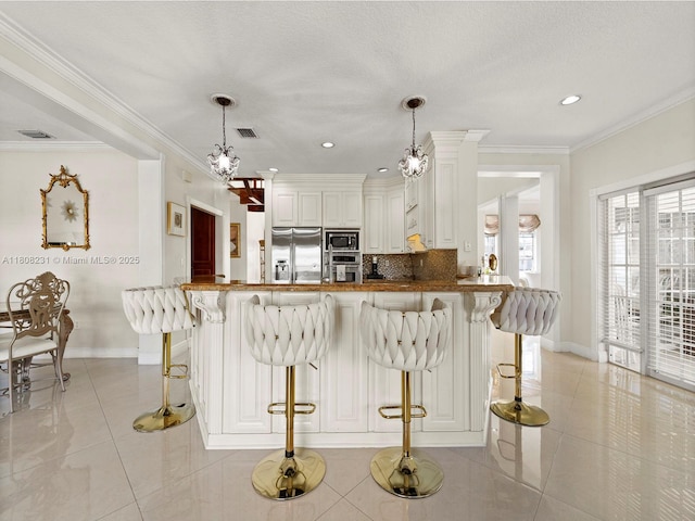 11230 SW 156th Ave, Miami, FL 33196 - kitchen with stainless steel appliances, light tile patterned floors, baseboards, decorative backsplash, and a kitchen bar