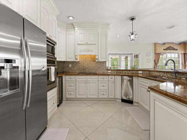 11230 SW 156th Ave, Miami, FL 33196 - kitchen featuring appliances with stainless steel finishes, a sink, beverage cooler, backsplash, and white cabinets