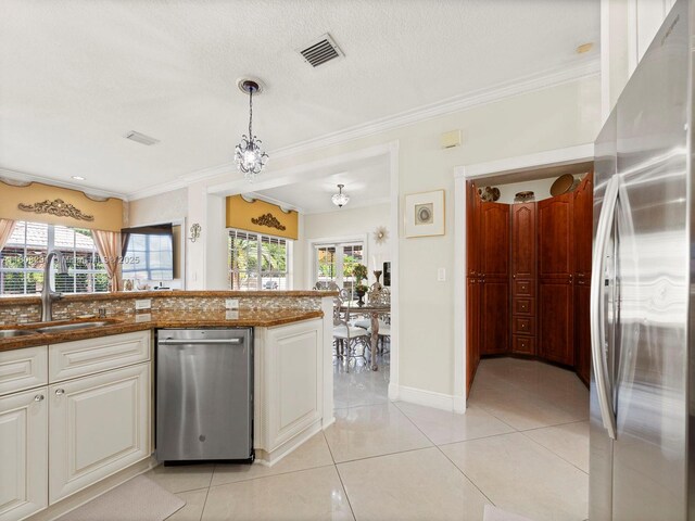 11230 SW 156th Ave, Miami, FL 33196 - kitchen featuring appliances with stainless steel finishes, a sink, ornamental molding, light tile patterned floors, and hanging light fixtures