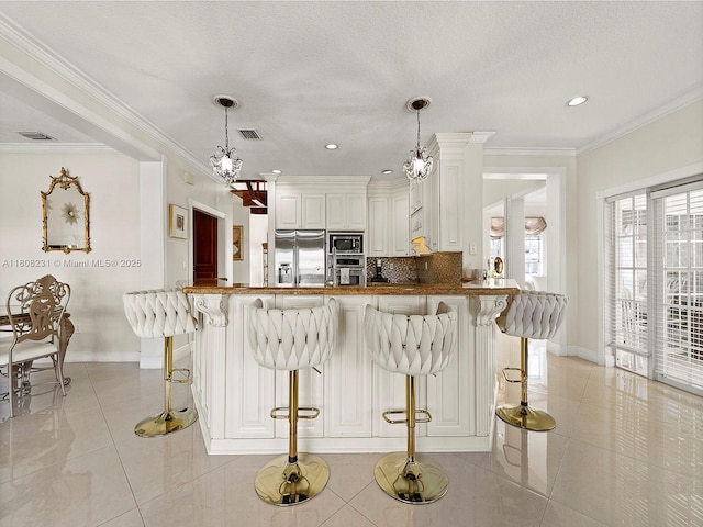 11230 SW 156th Ave, Miami, FL 33196 - kitchen featuring stainless steel appliances, light tile patterned floors, baseboards, decorative backsplash, and a kitchen bar