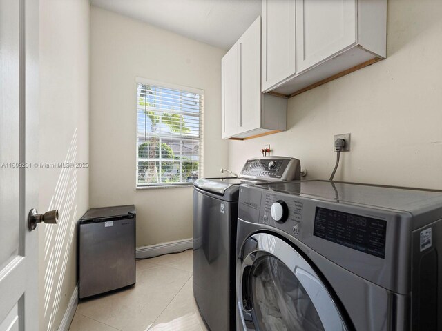 11230 SW 156th Ave, Miami, FL 33196 - washroom with cabinet space, washing machine and dryer, baseboards, and light tile patterned floors