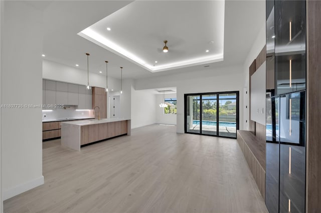 419NW7THAVE 419 NW 7th Ave, Cape Coral, FL 33993 - unfurnished living room with a raised ceiling, recessed lighting, light wood-type flooring, baseboards, and ceiling fan