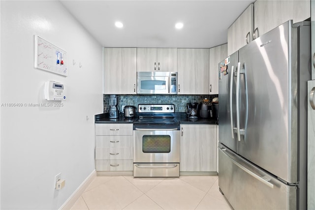 1401 SW 22nd St Unit 701, Miami, FL 33145 - kitchen featuring stainless steel appliances, dark countertops, light tile patterned floors, decorative backsplash, and recessed lighting