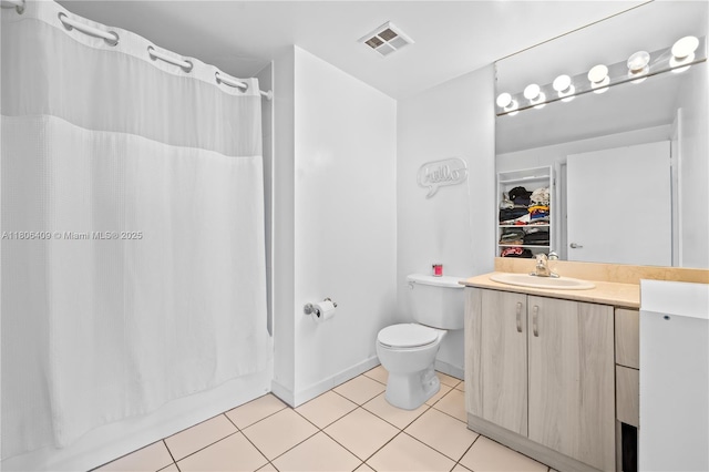1401 SW 22nd St Unit 701, Miami, FL 33145 - full bathroom with vanity, tile patterned flooring, toilet, and baseboards