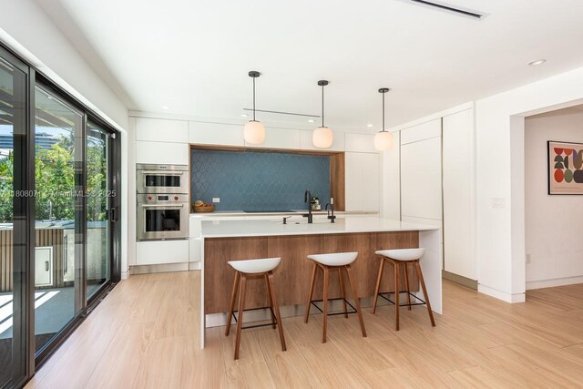 8959 Abbott Ave, Surfside, FL 33154 - kitchen with modern cabinets, white cabinetry, light countertops, stainless steel double oven, and recessed lighting