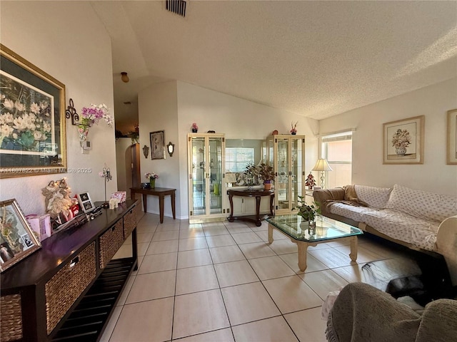 21468 SW 88th Ave, Cutler Bay, FL 33189 - living area featuring plenty of natural light, vaulted ceiling, light tile patterned flooring, and a textured ceiling