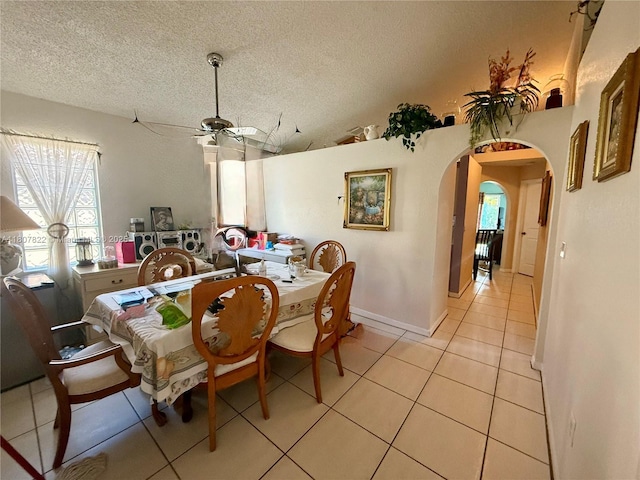 21468 SW 88th Ave, Cutler Bay, FL 33189 - dining space with light tile patterned flooring, arched walkways, a ceiling fan, and a textured ceiling