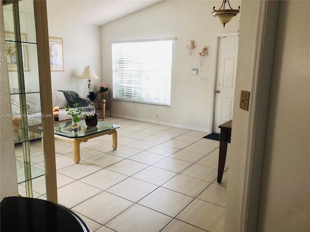 21468 SW 88th Ave, Cutler Bay, FL 33189 - living room with light tile patterned floors, vaulted ceiling, and baseboards