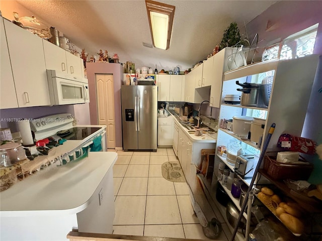 21468 SW 88th Ave, Cutler Bay, FL 33189 - kitchen featuring white appliances, light tile patterned flooring, light countertops, and white cabinets