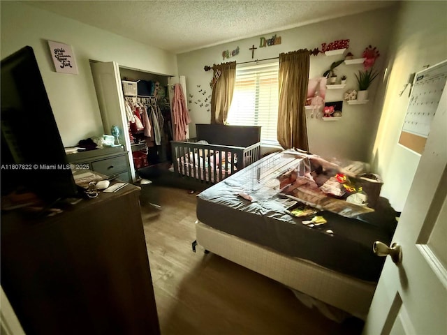 21468 SW 88th Ave, Cutler Bay, FL 33189 - bedroom with a closet, a textured ceiling, and wood finished floors