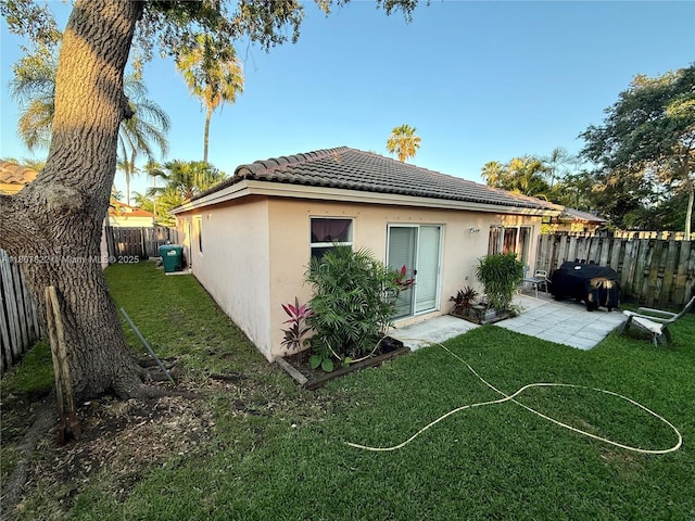21468 SW 88th Ave, Cutler Bay, FL 33189 - rear view of property with stucco siding, a tiled roof, and a patio