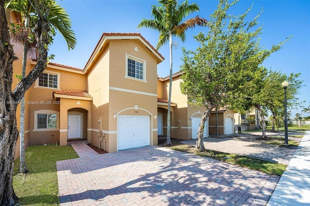1880 SE 3rd Dr, Homestead, FL 33033 - view of front facade featuring a tile roof, stucco siding, a garage, and driveway