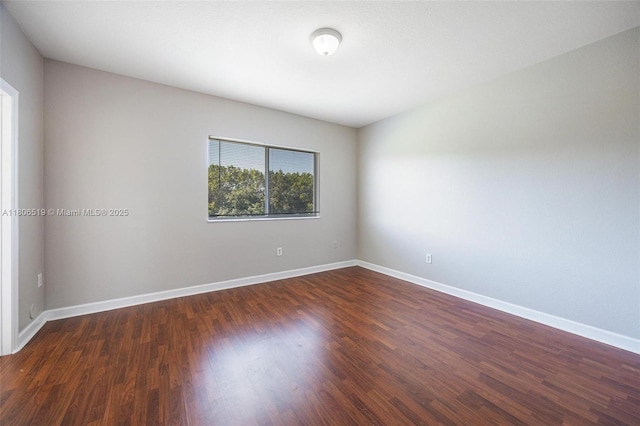 1880 SE 3rd Dr, Homestead, FL 33033 - spare room featuring dark wood-style flooring and baseboards