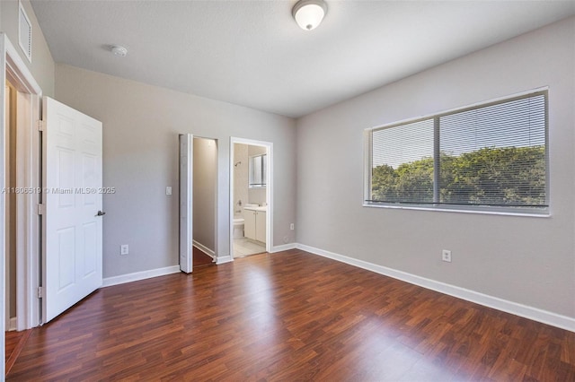 1880 SE 3rd Dr, Homestead, FL 33033 - unfurnished bedroom with wood finished floors, baseboards, and ensuite bathroom