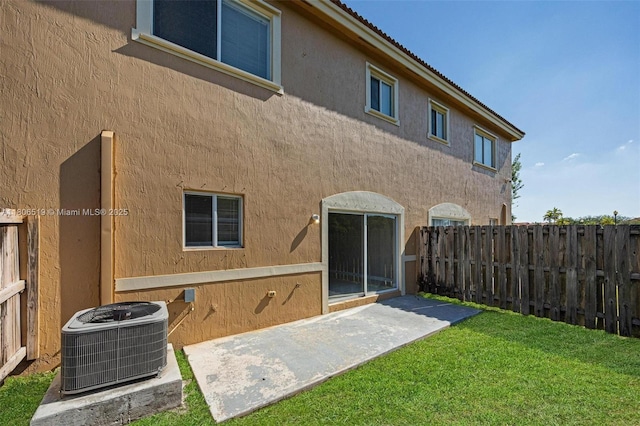 1880 SE 3rd Dr, Homestead, FL 33033 - back of house featuring central AC, a patio area, and stucco siding