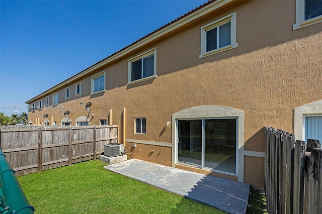 1880 SE 3rd Dr, Homestead, FL 33033 - back of property with stucco siding, central AC unit, a patio area, and a tiled roof