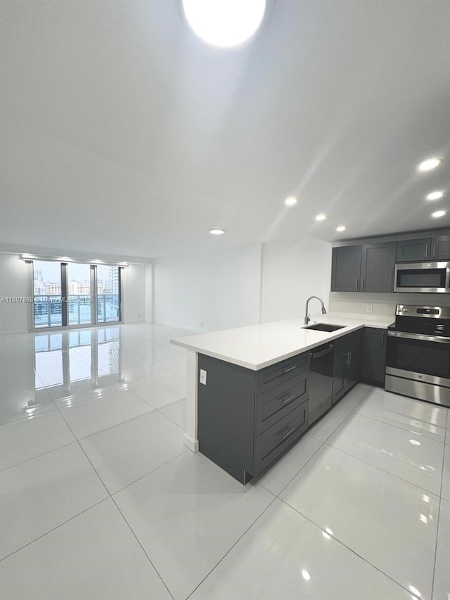 3800 S Ocean Dr Unit 1810, Hollywood, FL 33019 - kitchen with appliances with stainless steel finishes, a sink, a peninsula, light countertops, and light tile patterned floors
