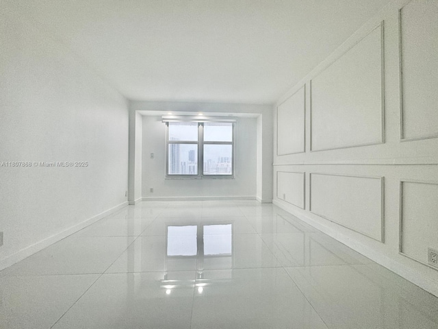 3800 S Ocean Dr Unit 1810, Hollywood, FL 33019 - empty room featuring baseboards and light tile patterned flooring