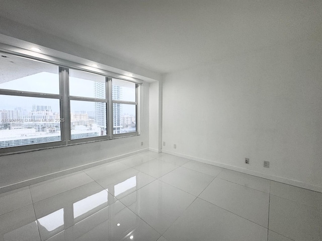 3800 S Ocean Dr Unit 1810, Hollywood, FL 33019 - tiled spare room with baseboards and a view of city