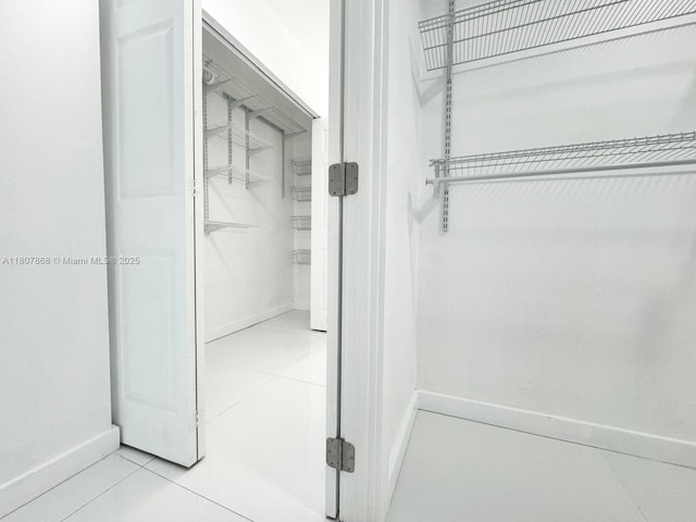 3800 S Ocean Dr Unit 1810, Hollywood, FL 33019 - bathroom with a spacious closet, baseboards, and tile patterned floors