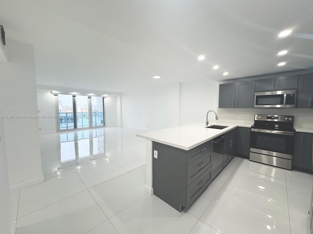 3800 S Ocean Dr Unit 1810, Hollywood, FL 33019 - kitchen with stainless steel appliances, a sink, gray cabinetry, light countertops, and a peninsula