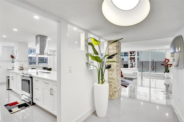 2751 S Ocean Dr Unit 301S, Hollywood, FL 33019 - kitchen with stainless steel range with electric cooktop, baseboards, white cabinetry, island exhaust hood, and recessed lighting