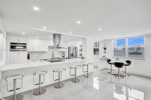 2751 S Ocean Dr Unit 301S, Hollywood, FL 33019 - kitchen with island range hood, stainless steel fridge with ice dispenser, a kitchen breakfast bar, white cabinets, and baseboards