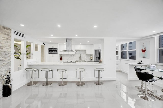 2751 S Ocean Dr Unit 301S, Hollywood, FL 33019 - kitchen with exhaust hood, stainless steel fridge, a breakfast bar, white cabinets, and recessed lighting