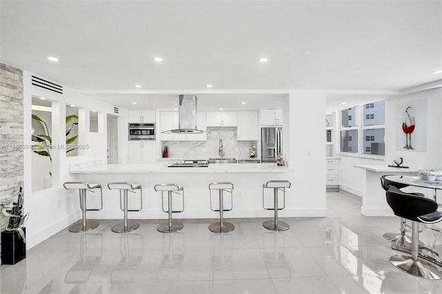 2751 S Ocean Dr Unit 301S, Hollywood, FL 33019 - kitchen featuring stainless steel appliances, ventilation hood, a kitchen breakfast bar, white cabinets, and recessed lighting