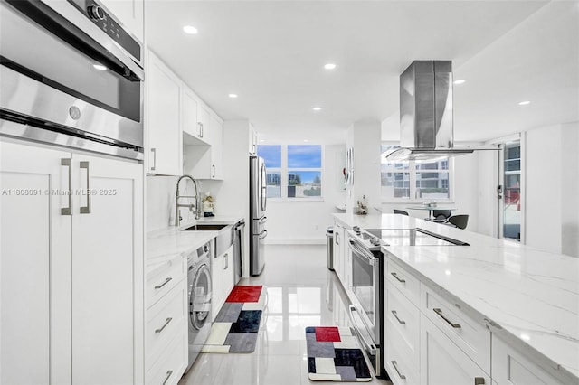 2751 S Ocean Dr Unit 301S, Hollywood, FL 33019 - kitchen with stainless steel appliances, island exhaust hood, a sink, washer / clothes dryer, and recessed lighting