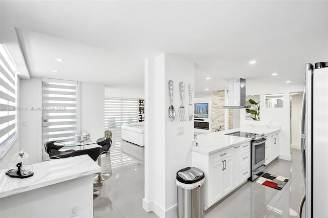 2751 S Ocean Dr Unit 301S, Hollywood, FL 33019 - kitchen with stainless steel appliances, island exhaust hood, white cabinets, light stone countertops, and recessed lighting
