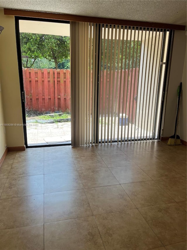 8004 SW 149th Ave Unit C102, Miami, FL 33193 - empty room with plenty of natural light, baseboards, and a textured ceiling