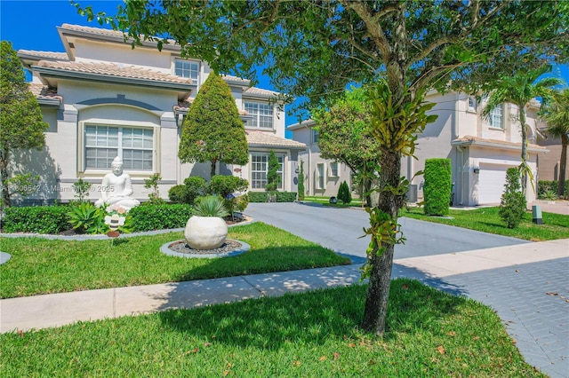 4604 SW 132nd Ave, Miramar, FL 33027 - mediterranean / spanish-style house featuring stucco siding, a front yard, a tiled roof, and driveway