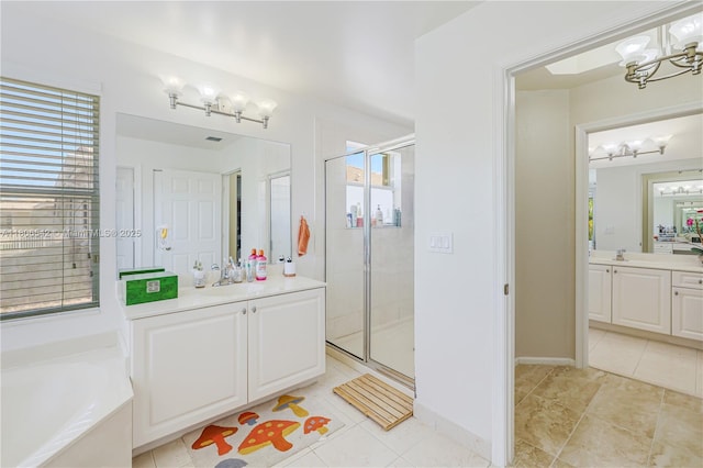 4604 SW 132nd Ave, Miramar, FL 33027 - full bathroom featuring a chandelier, a stall shower, two vanities, and a bath