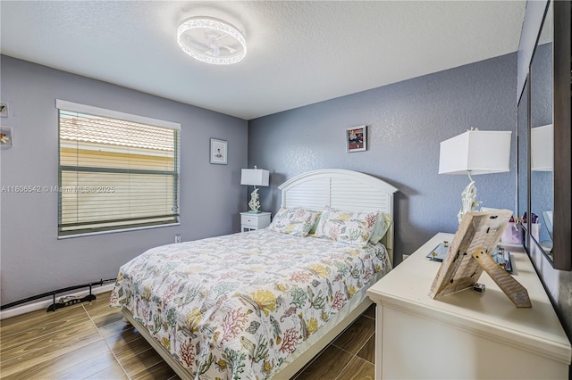 4604 SW 132nd Ave, Miramar, FL 33027 - bedroom with a textured wall, wood finished floors, and a textured ceiling