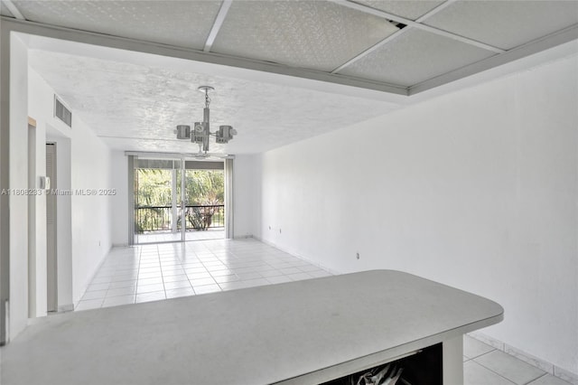 7100 NW 17th St Unit 306, Plantation, FL 33313 - unfurnished dining area with light tile patterned floors, a chandelier, and a textured ceiling
