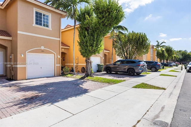 1985 SE 3rd St, Homestead, FL 33033 - townhome / multi-family property with a tiled roof, stucco siding, driveway, and an attached garage