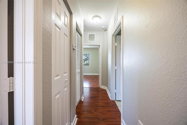 1985 SE 3rd St, Homestead, FL 33033 - hall with a textured wall, dark wood finished floors, and baseboards