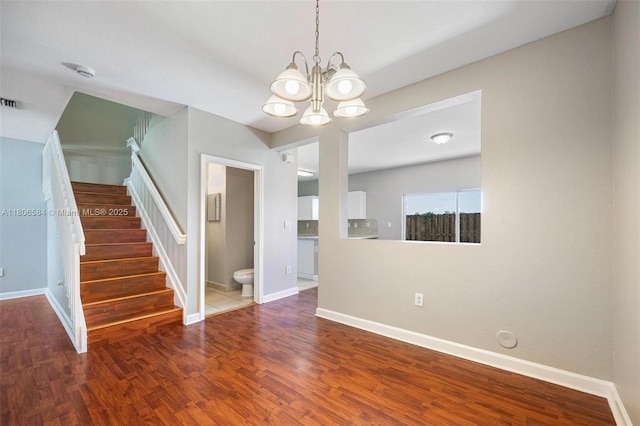 1985 SE 3rd St, Homestead, FL 33033 - spare room with a chandelier, stairs, wood finished floors, and baseboards