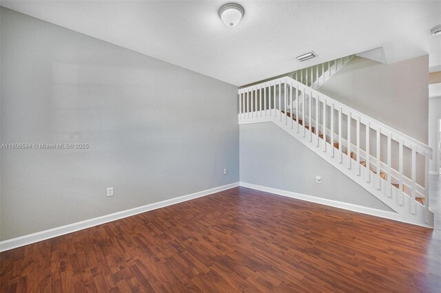 1985 SE 3rd St, Homestead, FL 33033 - unfurnished living room with wood finished floors, baseboards, and stairway