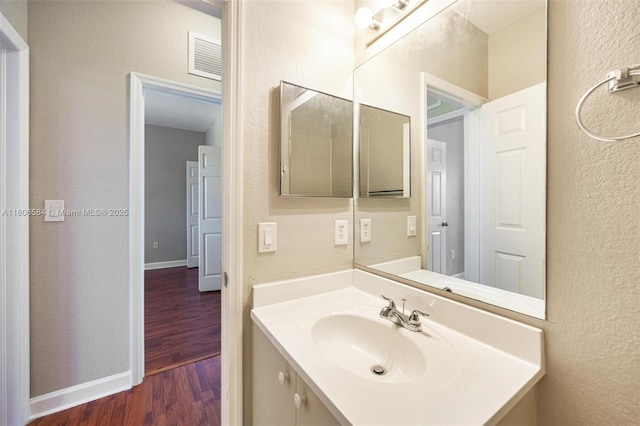 1985 SE 3rd St, Homestead, FL 33033 - bathroom featuring wood finished floors, vanity, and a textured wall