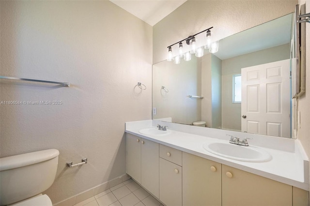 1985 SE 3rd St, Homestead, FL 33033 - full bathroom featuring toilet, double vanity, tile patterned flooring, and baseboards